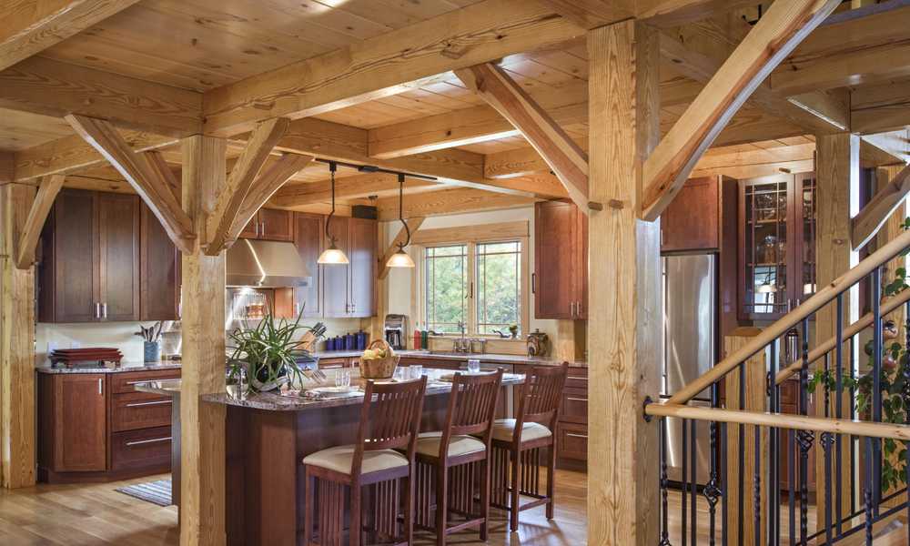 The kitchen of a timber frame home showcasing exposed beams, crossmembers, and columns.